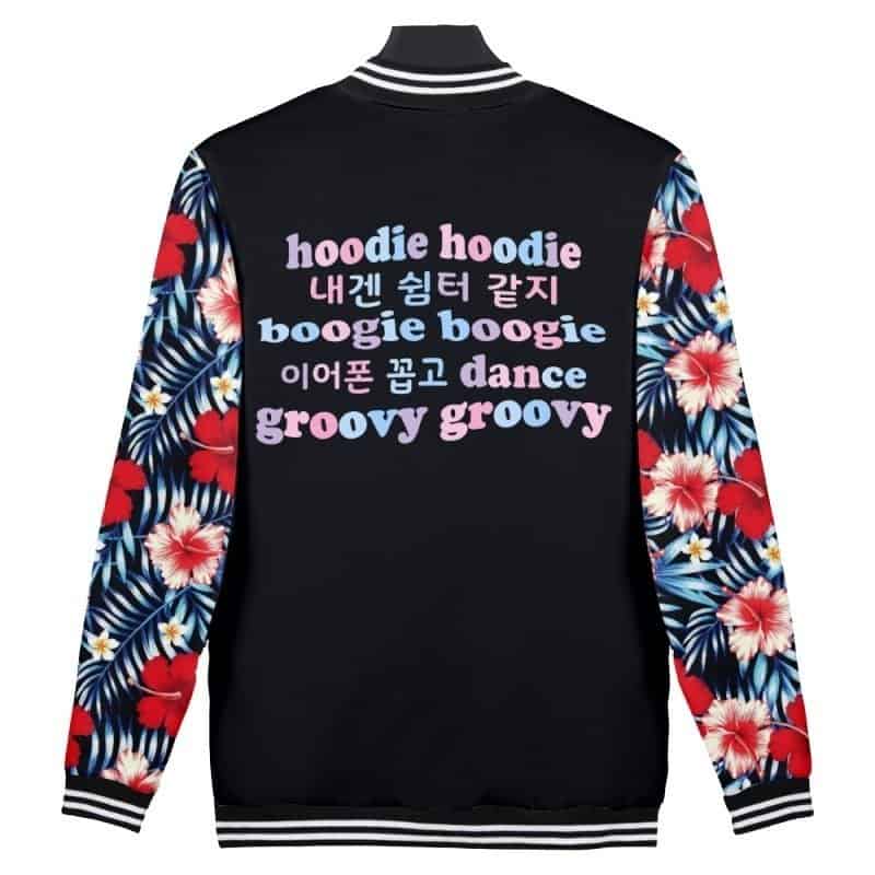 Colorful K-pop merch hoodie with floral sleeves and playful lyrics printed on the back.